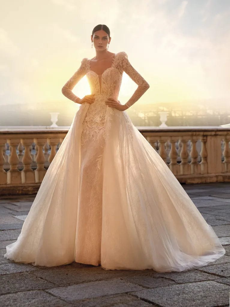 Ruffle skirt – Skirt with ruffled edges or layers, adding movement and texture.Ruffle skirt – Skirt with ruffled edges or layers, adding movement and texture.Pronovias Fiora + Overskirt - Size 12